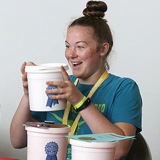 Trainer holding container with blue ribbon sticker